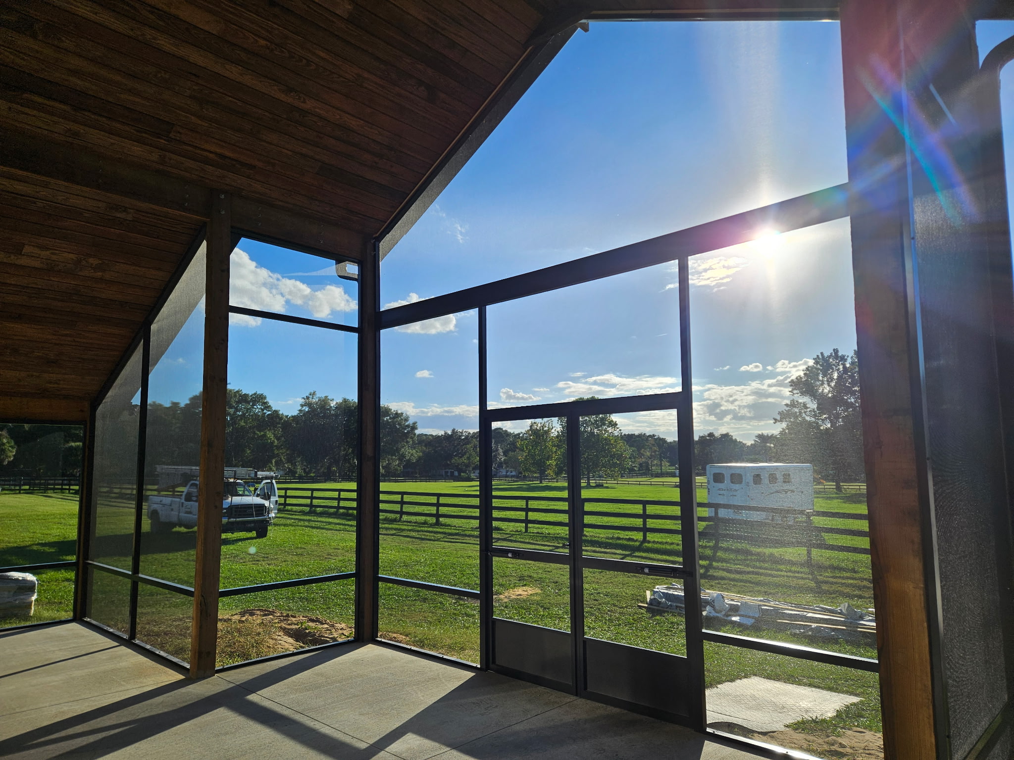 Aluminum screen enclosure enclosing a Florida patio with open views and bug protection
