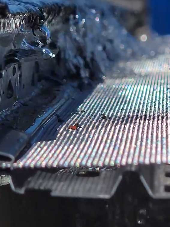 Water flowing over gutter guard designed to block debris and prevent clogs