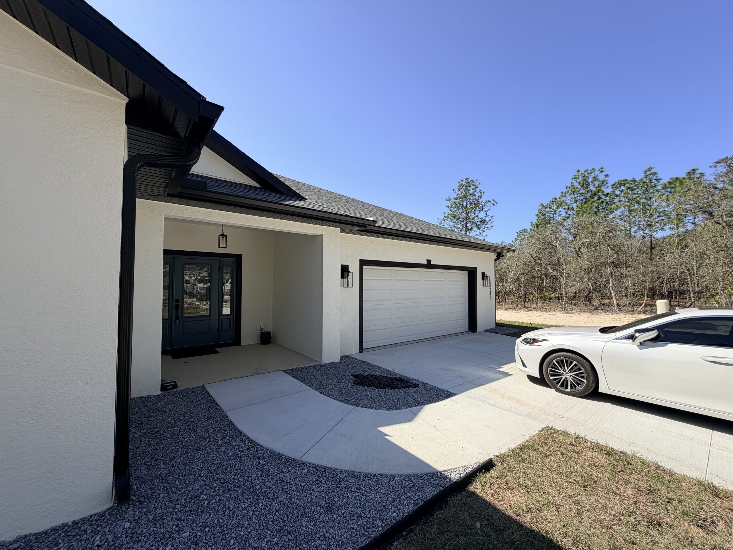 Black seamless gutters installed on a Central Florida home to improve drainage and protect the roof and foundation