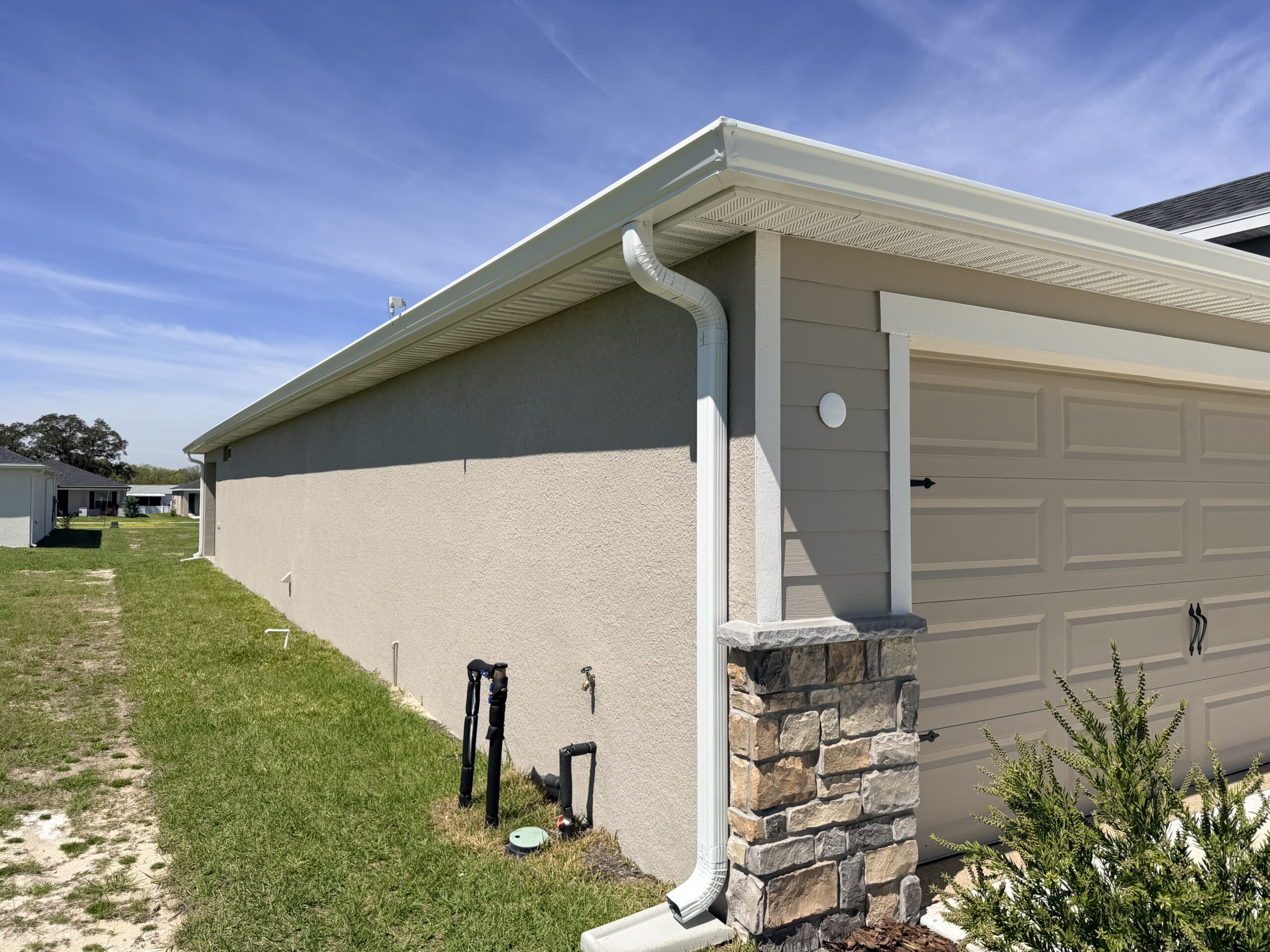 Seamless gutter installation on a Central Florida home directing rainwater away from the roof and foundation